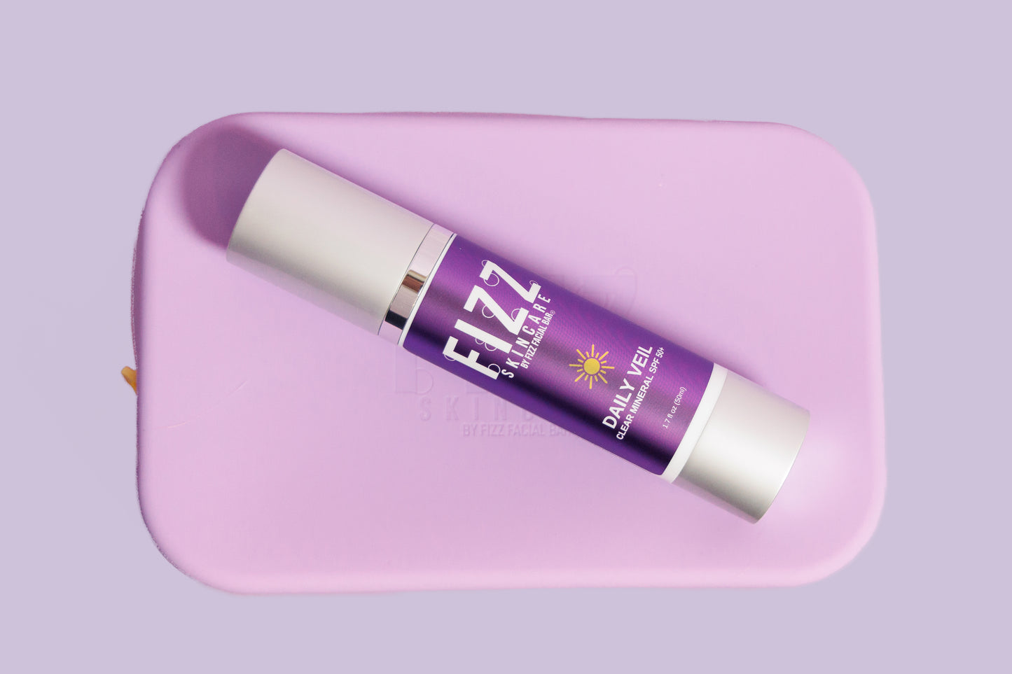 Daily Veil Mineral SPF with purple silicone bag